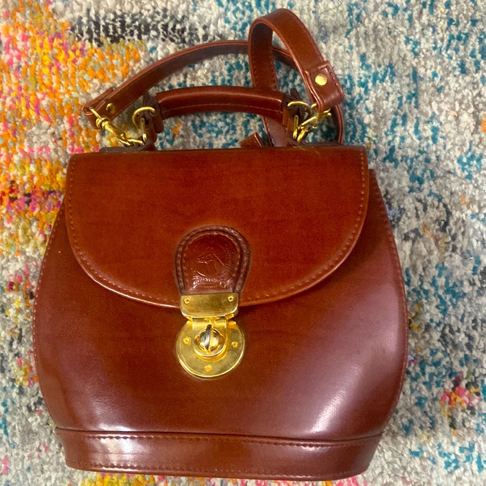 Vintage leather purse with ornate horse decoration at clasp